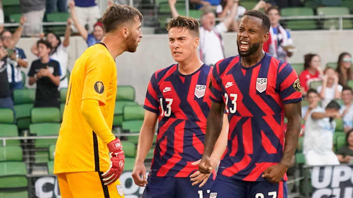 USA's Kellyn Acosta, Matt Turner and Matthew Hoppe celebrate Qatar's penalty kick miss